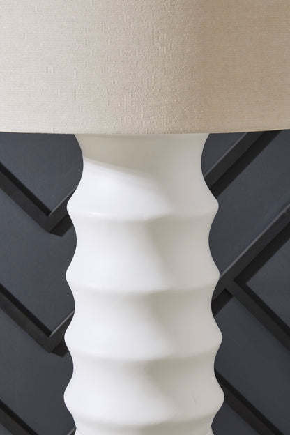 White ribbed column floor lamp with tapered fabric drum shade, close-up view