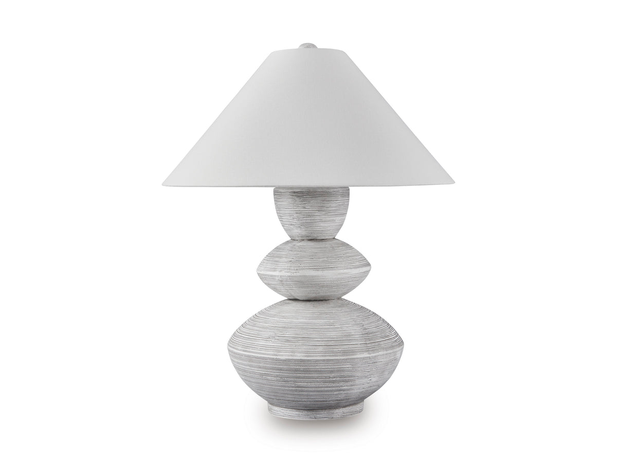 Table lamp with white shade and gray sculpted stacked base