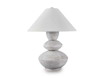 Table lamp with white shade and gray sculpted stacked base