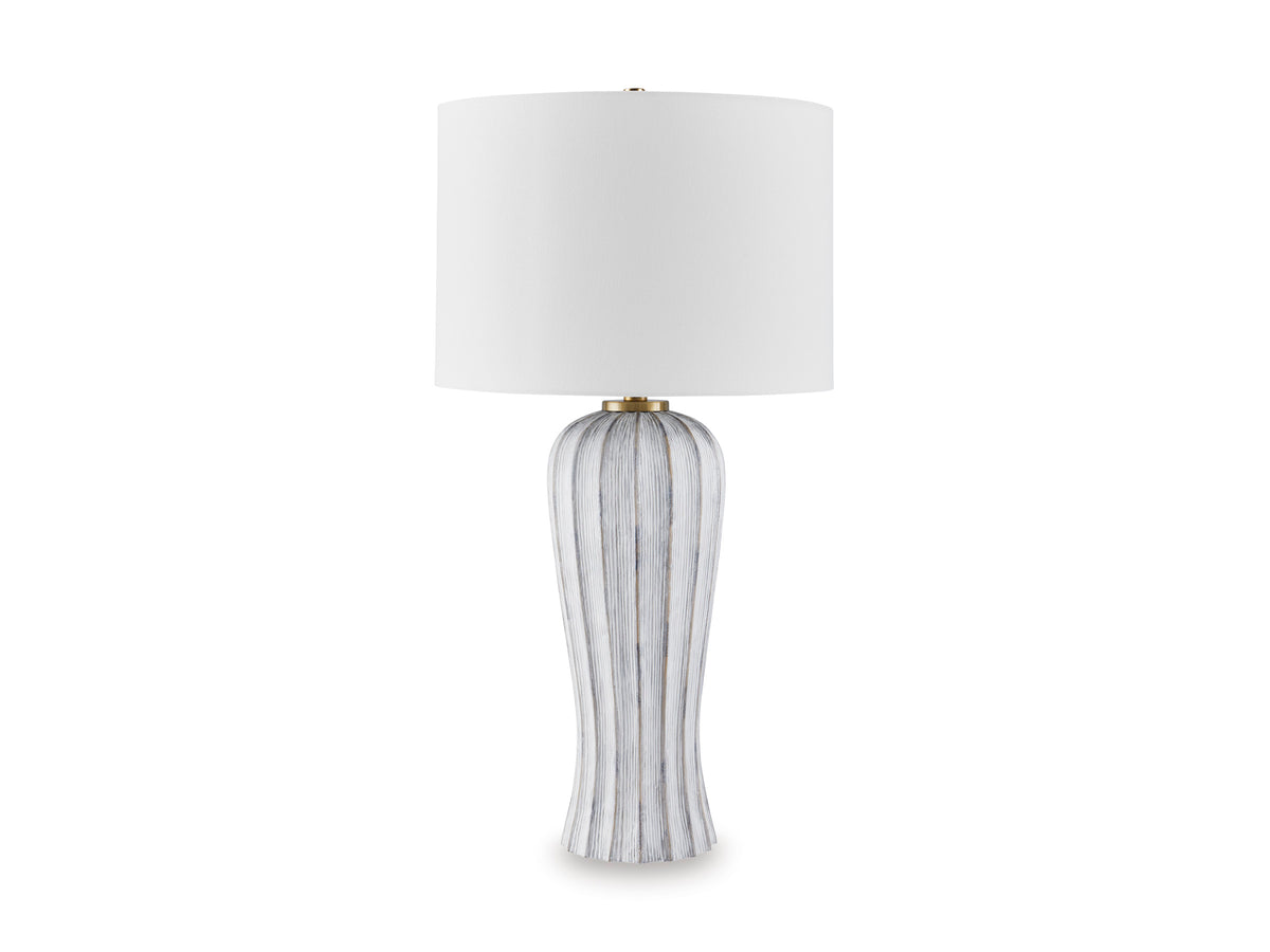Table lamp with white drum shade and tall vertical striped base with gold neck