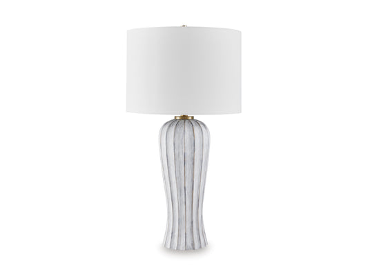 Table lamp with white drum shade and tall vertical striped base with gold neck