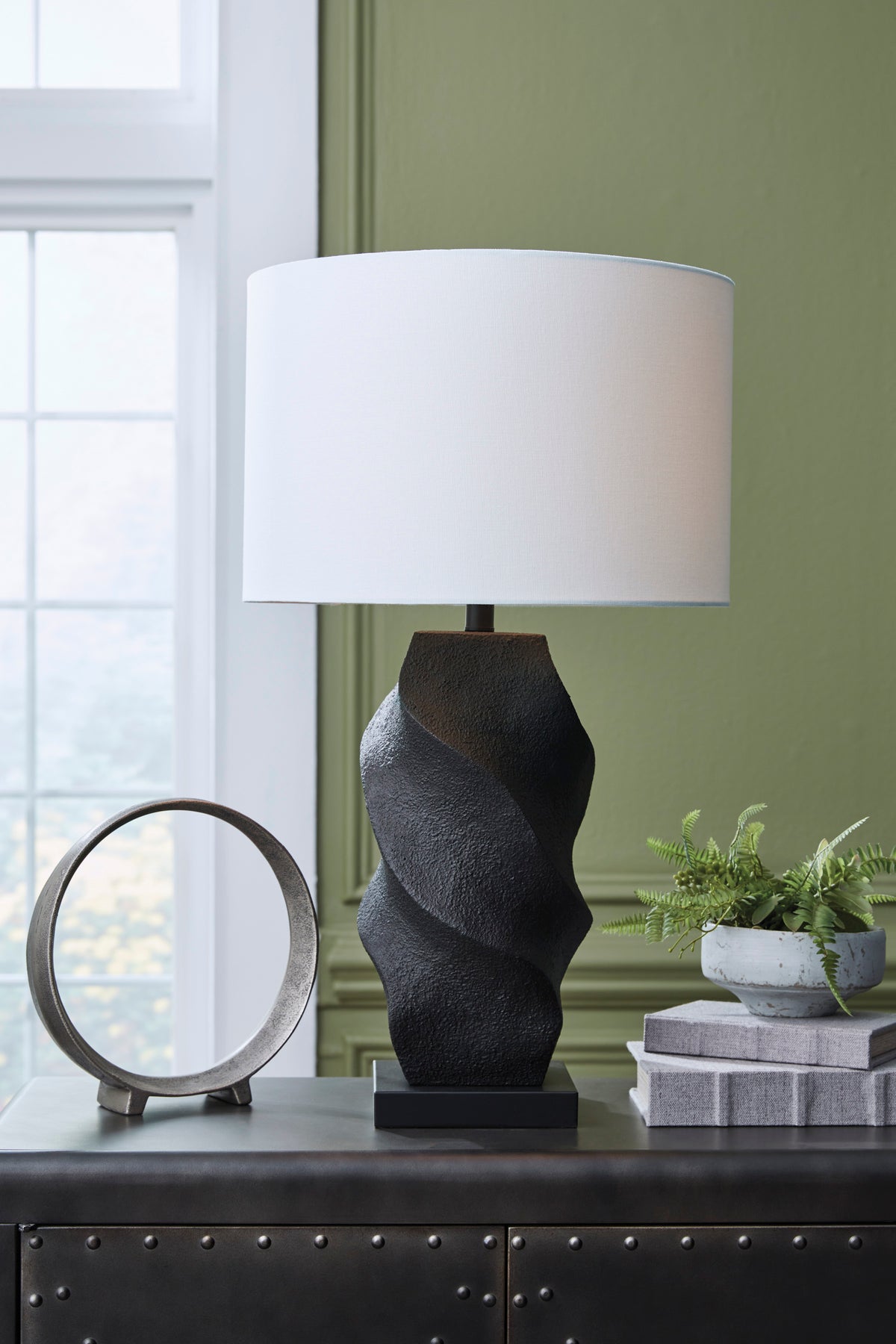 Textured poly table lamp with black wavy base and white fabric shade