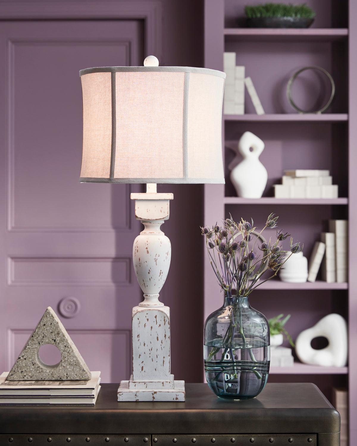 Distressed ceramic table lamp with beige drum shade and speckled white base