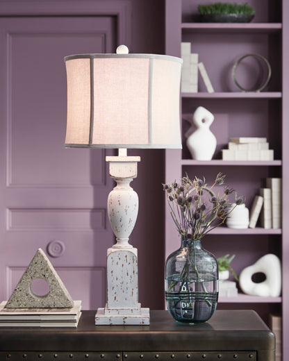 Distressed ceramic table lamp with beige drum shade and speckled white base