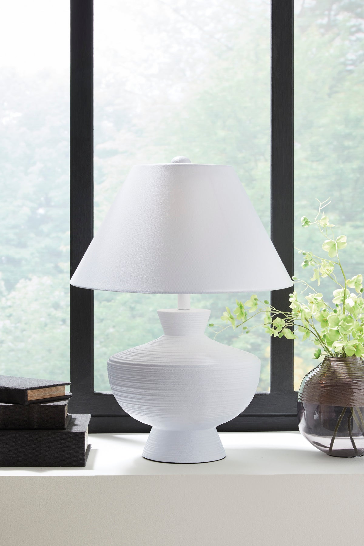 White poly table lamp with pleated column base and white fabric drum shade