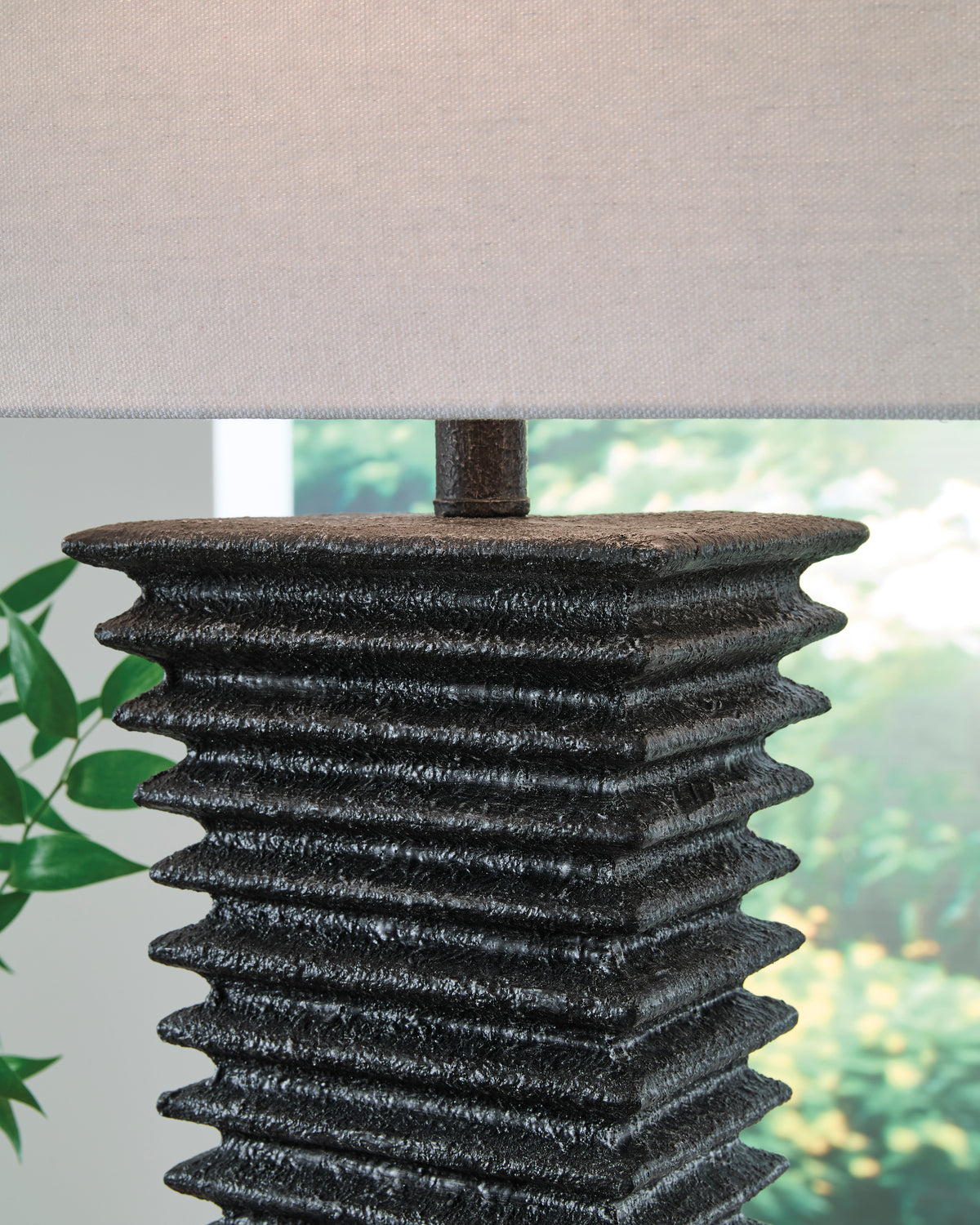 Black ribbed textured lamp base with white fabric drum shade