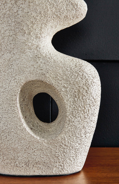 Close-up of textured ceramic table lamp base with oval cutout and curved shape