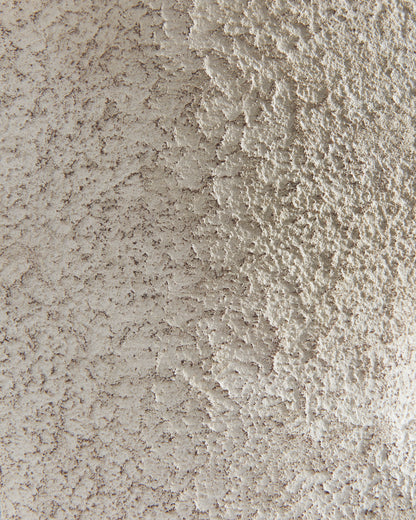 Textured ceramic lamp base surface detail in light beige