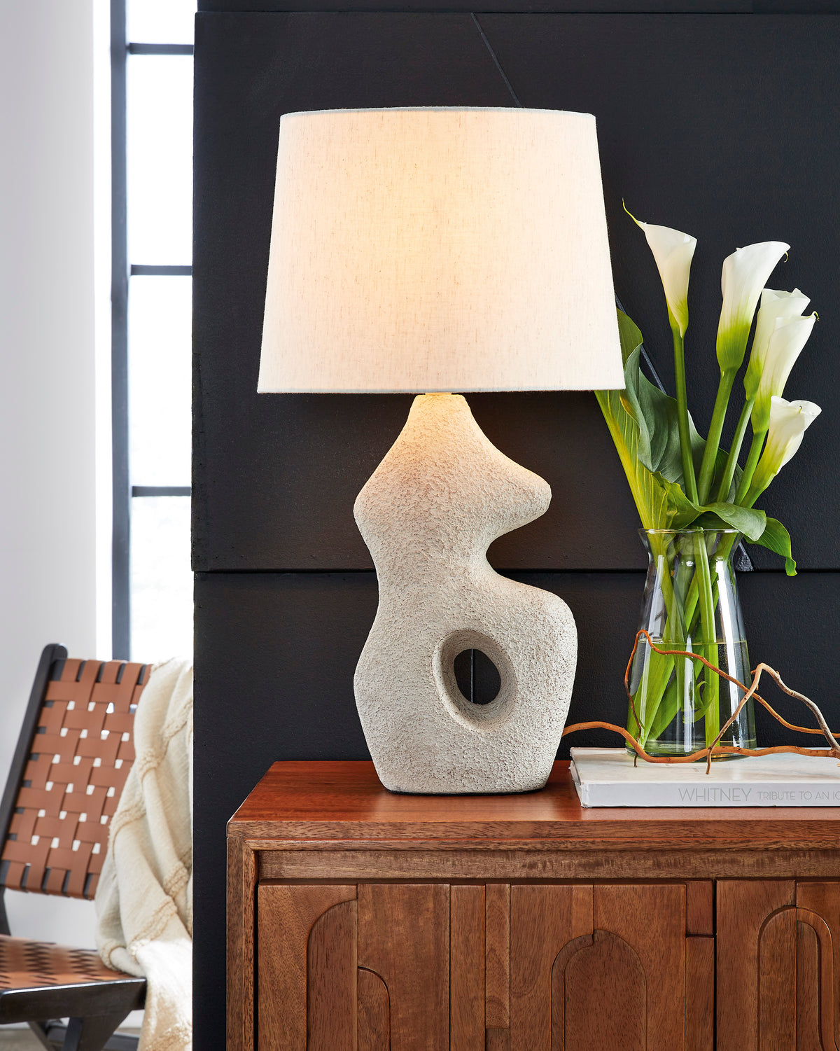 Textured ceramic table lamp with off-white drum shade and round cutout