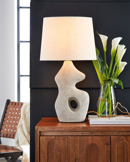 Textured ceramic table lamp with off-white drum shade and round cutout