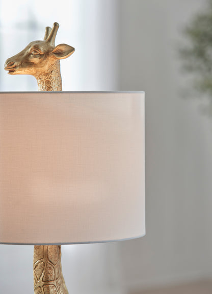 Table lamp side view with giraffe head and beige drum shade