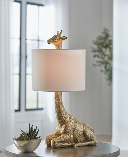 Table lamp with giraffe figure base and beige drum shade