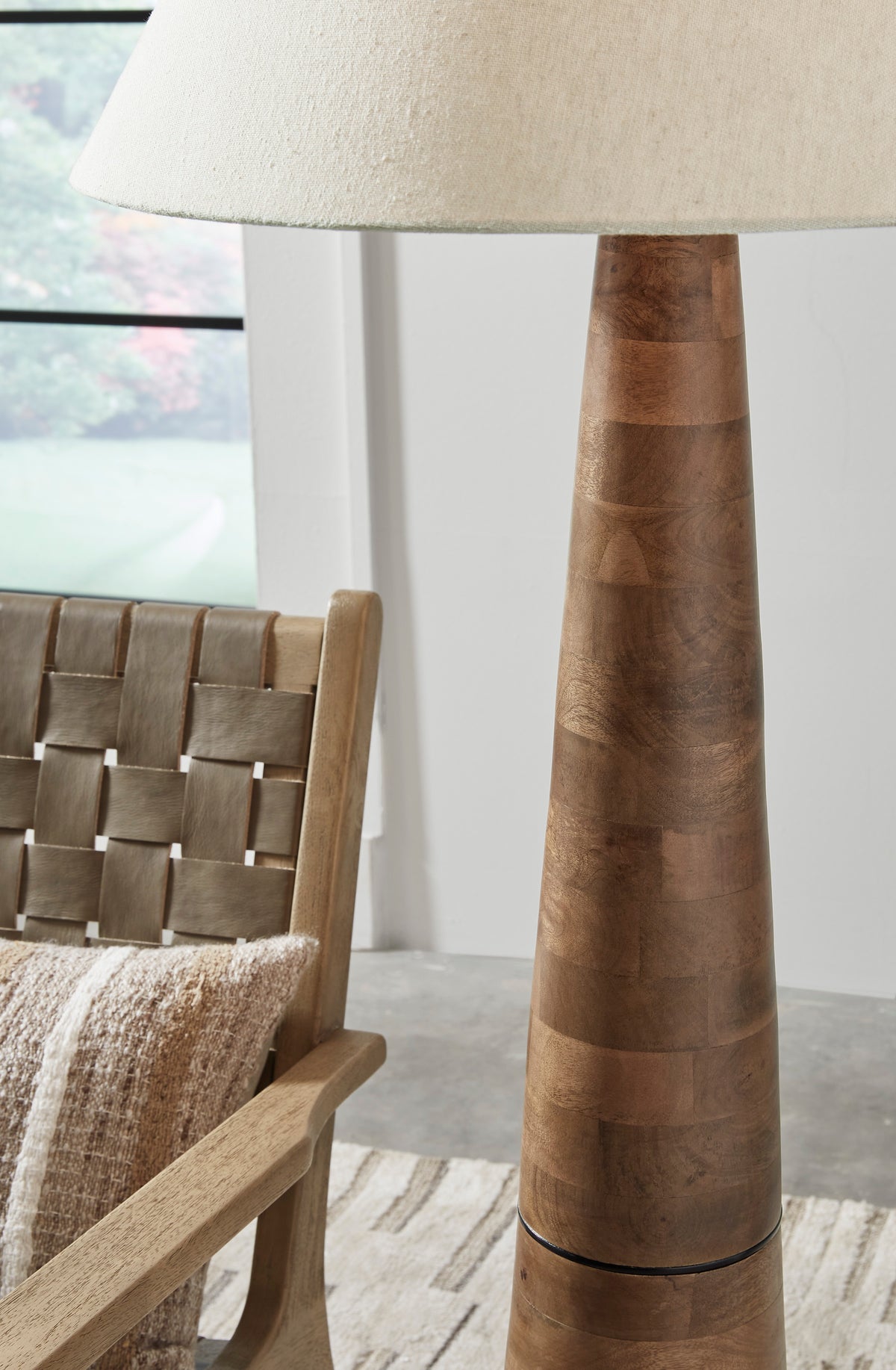 Wood floor lamp with beige fabric drum shade and segmented wood column base