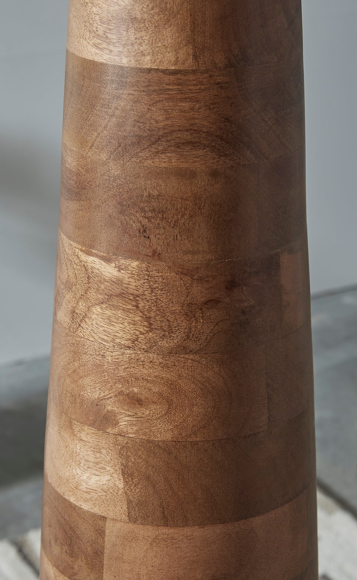 Segmented wood column lamp base with natural brown grain and ringed sections