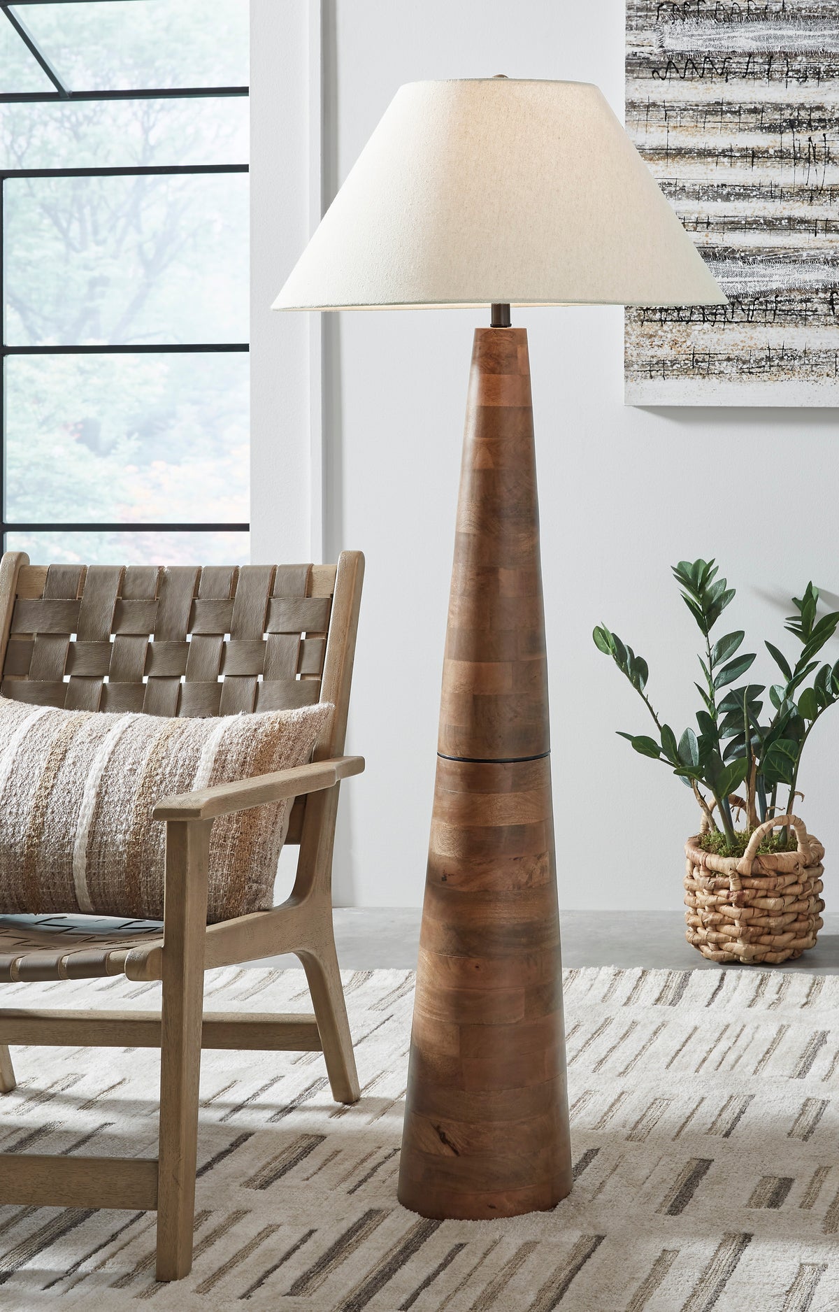 Tall wood floor lamp with beige fabric drum shade and segmented wood column base