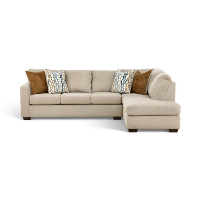 Beige sectional chaise sofa with light upholstery and patterned throw pillows