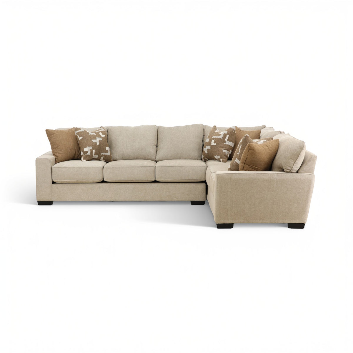 Beige sectional sofa with upholstered chaise, plush cushions, and patterned throw pillows