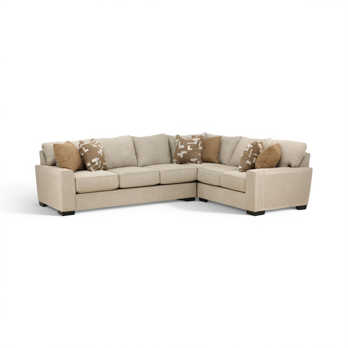 Beige corner sectional sofa with low profile, tufted cushions, and patterned pillows