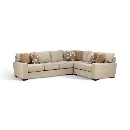Beige corner sectional sofa with low profile, tufted cushions, and patterned pillows