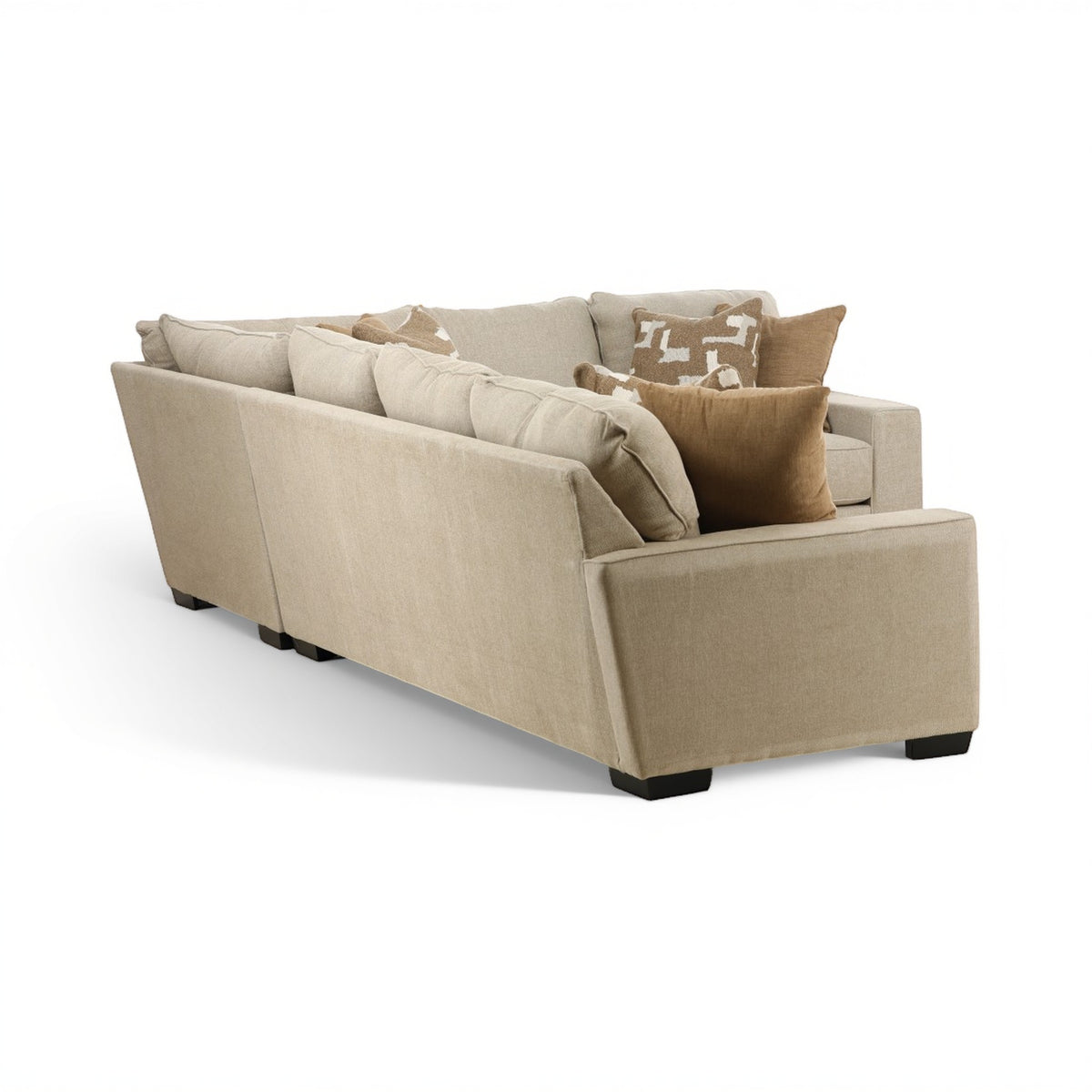 Beige sectional sofa with wide chaise end, tufted cushions, and decorative pillows