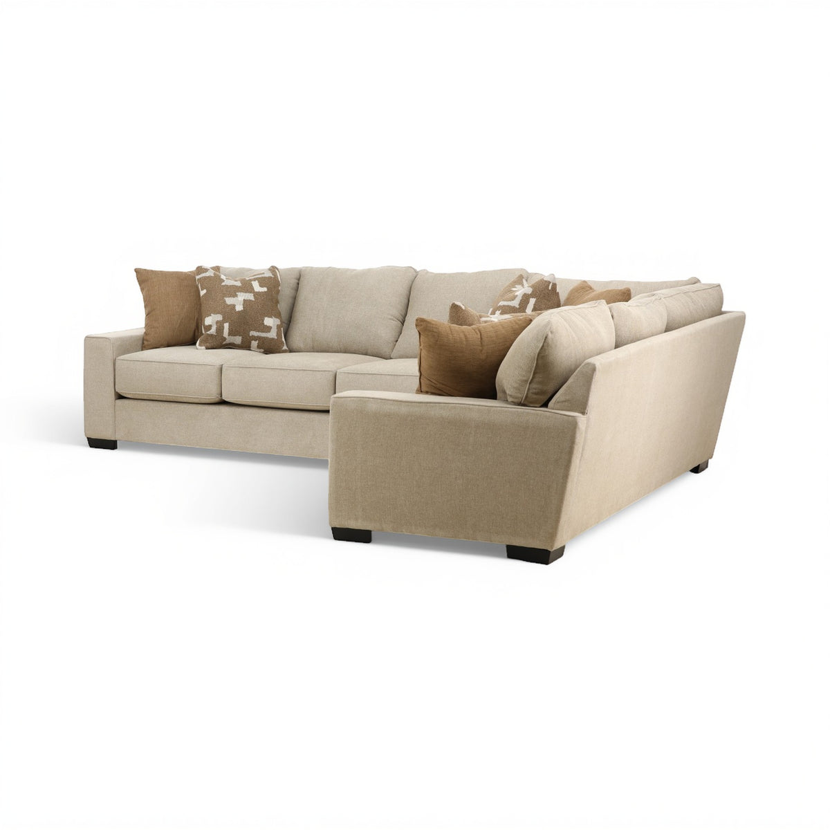 Beige sectional sofa with corner chaise, square cushions, and patterned throw pillow