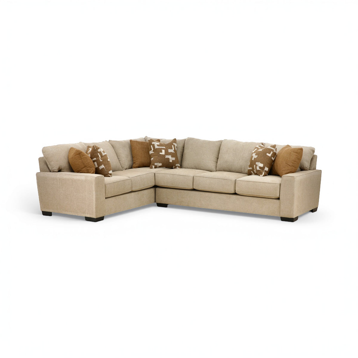 Beige sectional sofa with chaise and patterned throw pillows