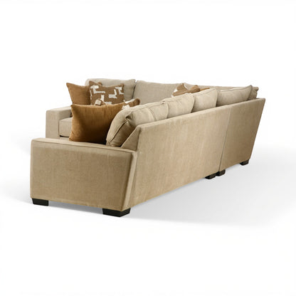 Beige sectional sofa with chaise end and layered throw pillows