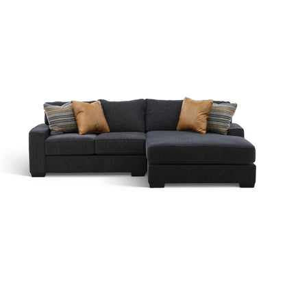2-piece sectional with chaise in dark charcoal fabric, with tan and striped accent pillows