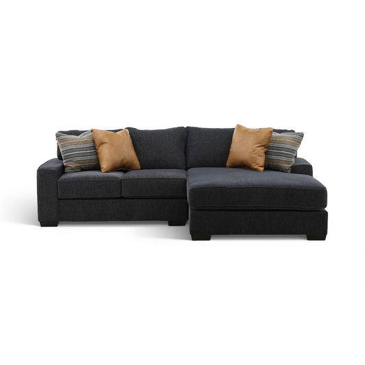2-piece sectional with chaise in dark charcoal fabric, with tan and striped accent pillows