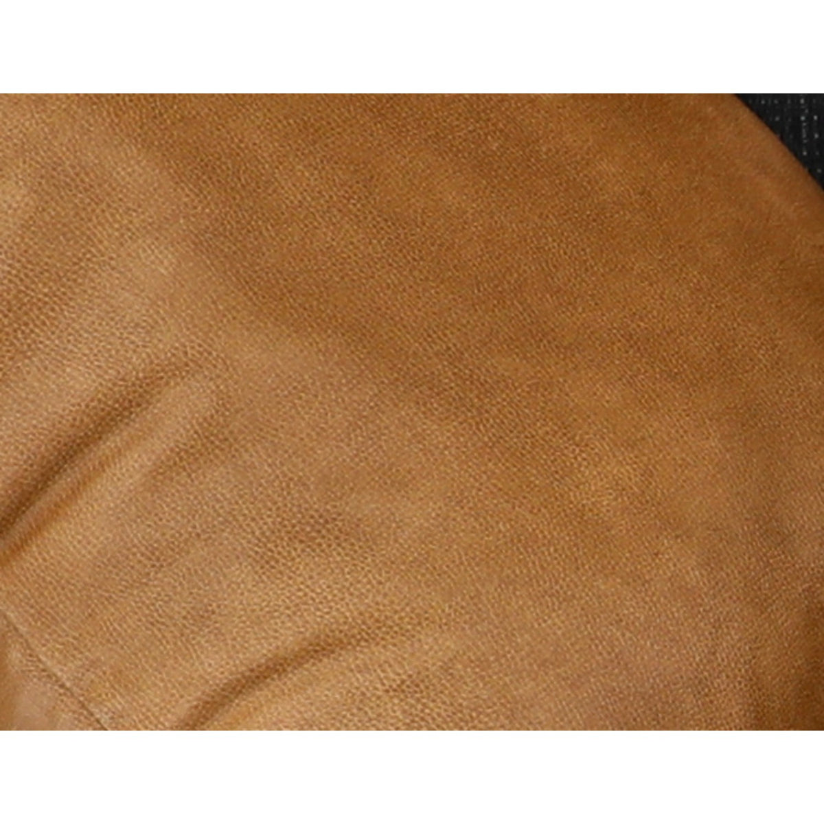 Close-up of tan cushion fabric on the sectional throw pillow