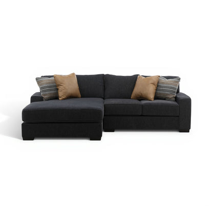 Charcoal fabric sectional sofa with chaise and tan throw pillows