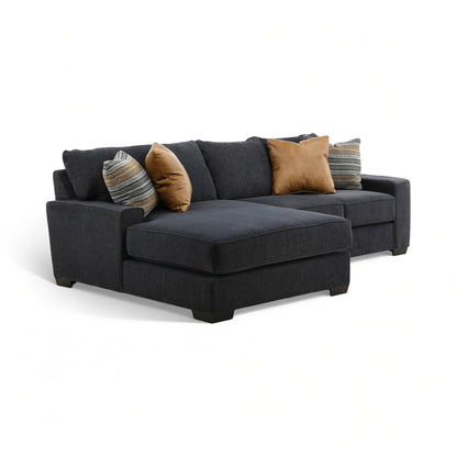 Charcoal fabric sectional chaise with bench seat and tan accent pillows