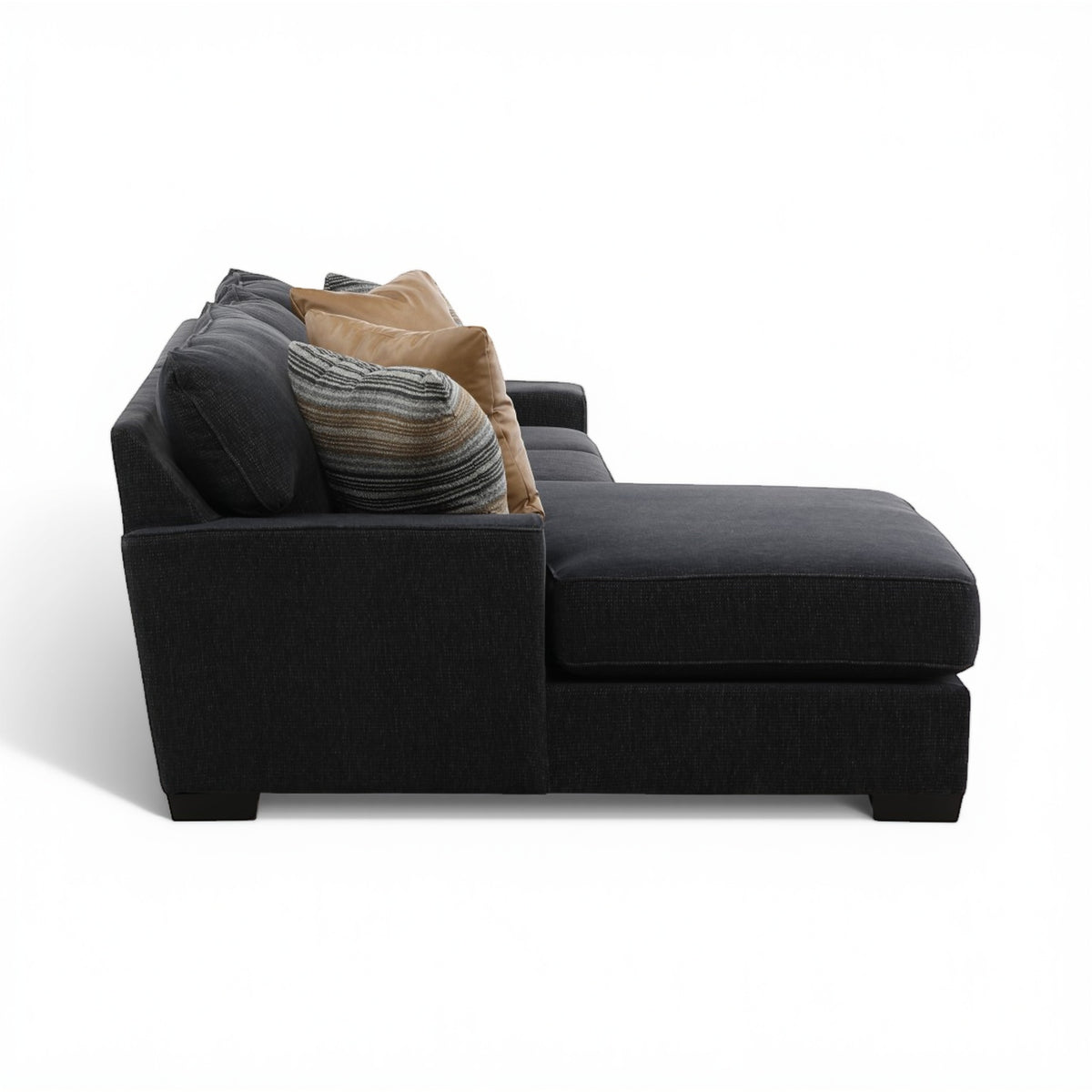 Charcoal chaise sectional with stacked pillows in tan and striped gray