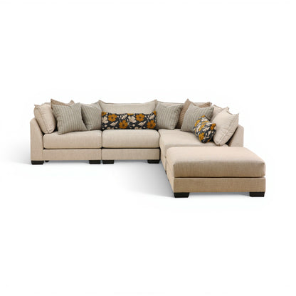 Beige modular sectional sofa with right chaise and multiple throw pillows