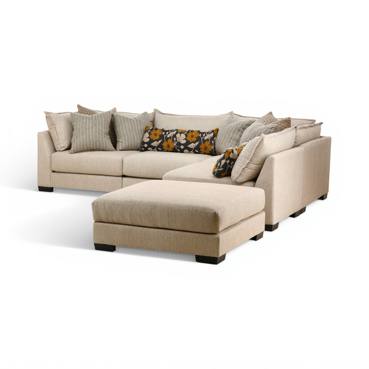 Beige modular sectional sofa with corner chaise and decorative throw pillows
