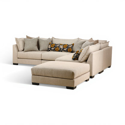 Beige modular sectional sofa with corner chaise and decorative throw pillows