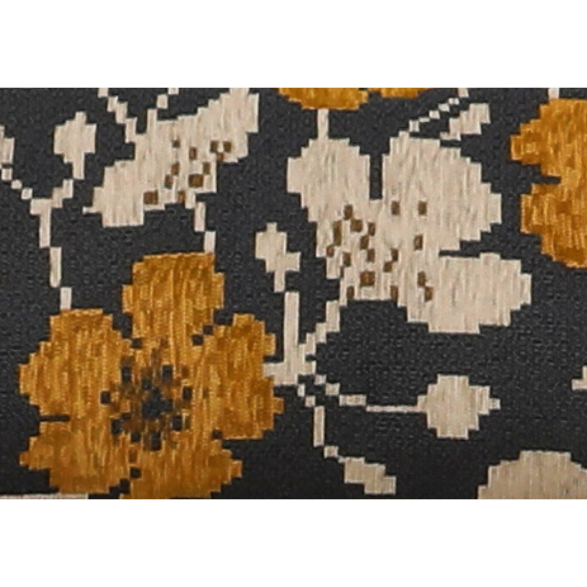 Close-up of black, white, and gold floral patterned throw fabric