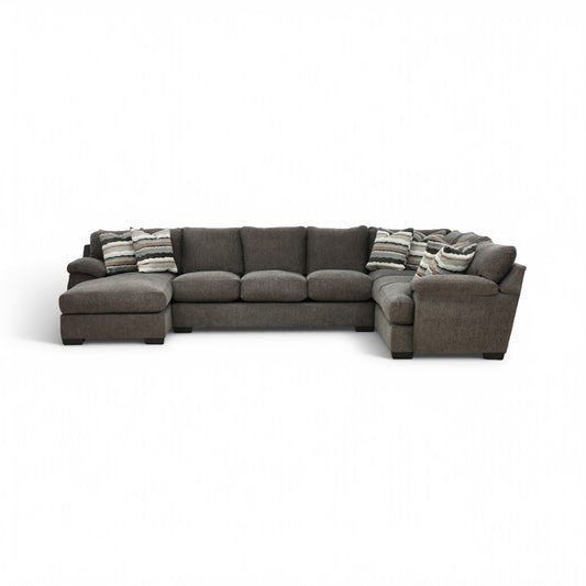 Dark gray 3-piece sectional sofa with chaise and striped throw pillows