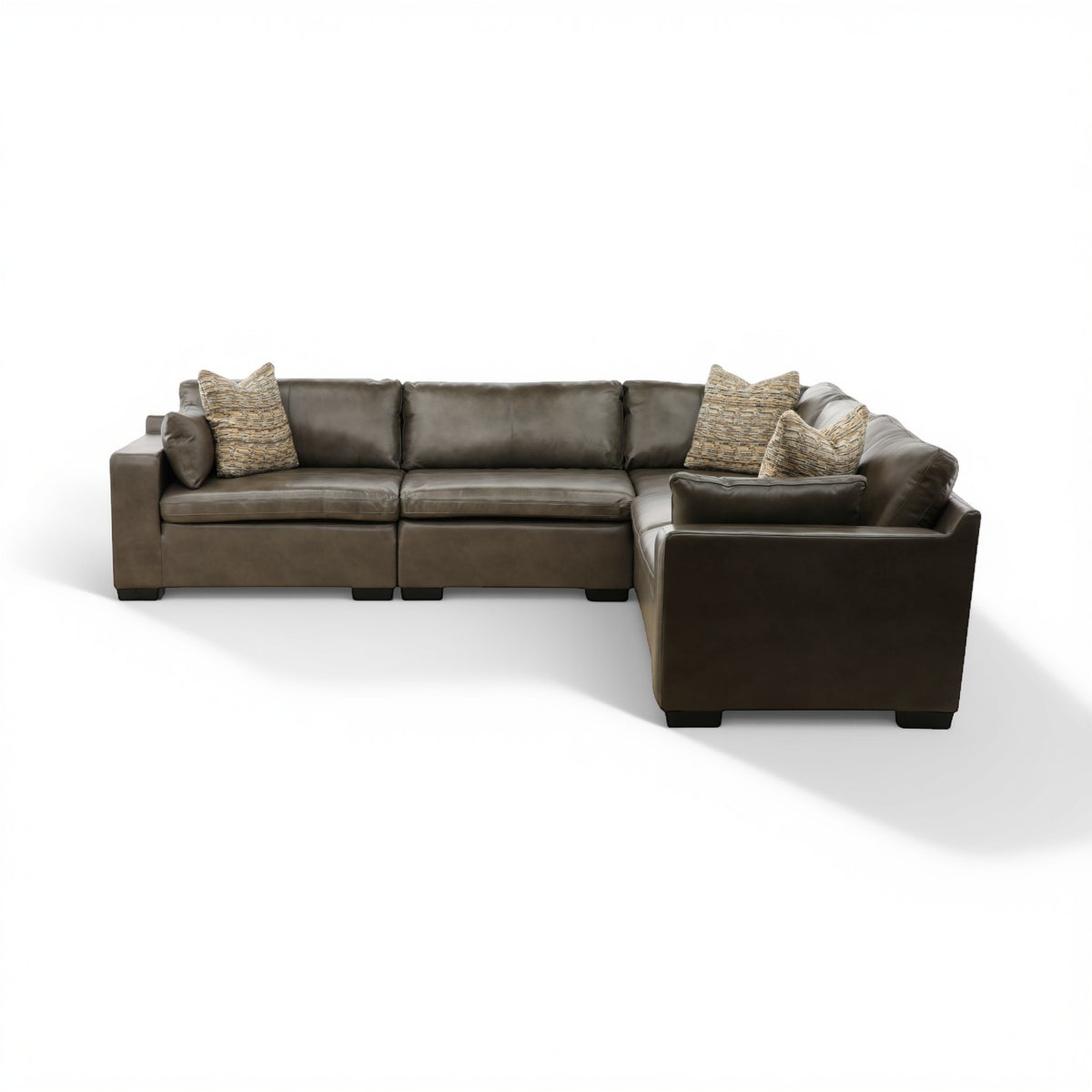 Dark brown leather modular sectional with corner ottoman and 4 throw pillows