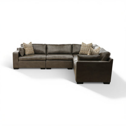 Dark brown leather modular sectional with corner ottoman and 4 throw pillows
