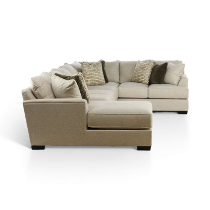 Three-piece sectional sofa with chaise, light beige upholstery and layered throw pillows