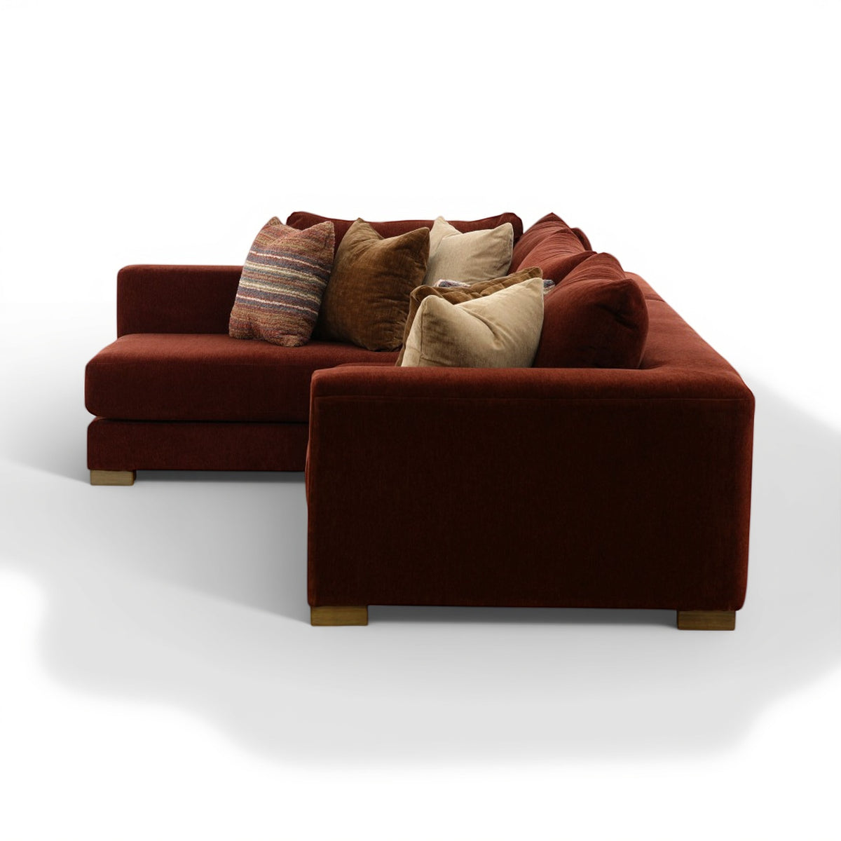 Corner sectional sofa in dark brown with seat cushions and layered throw pillows