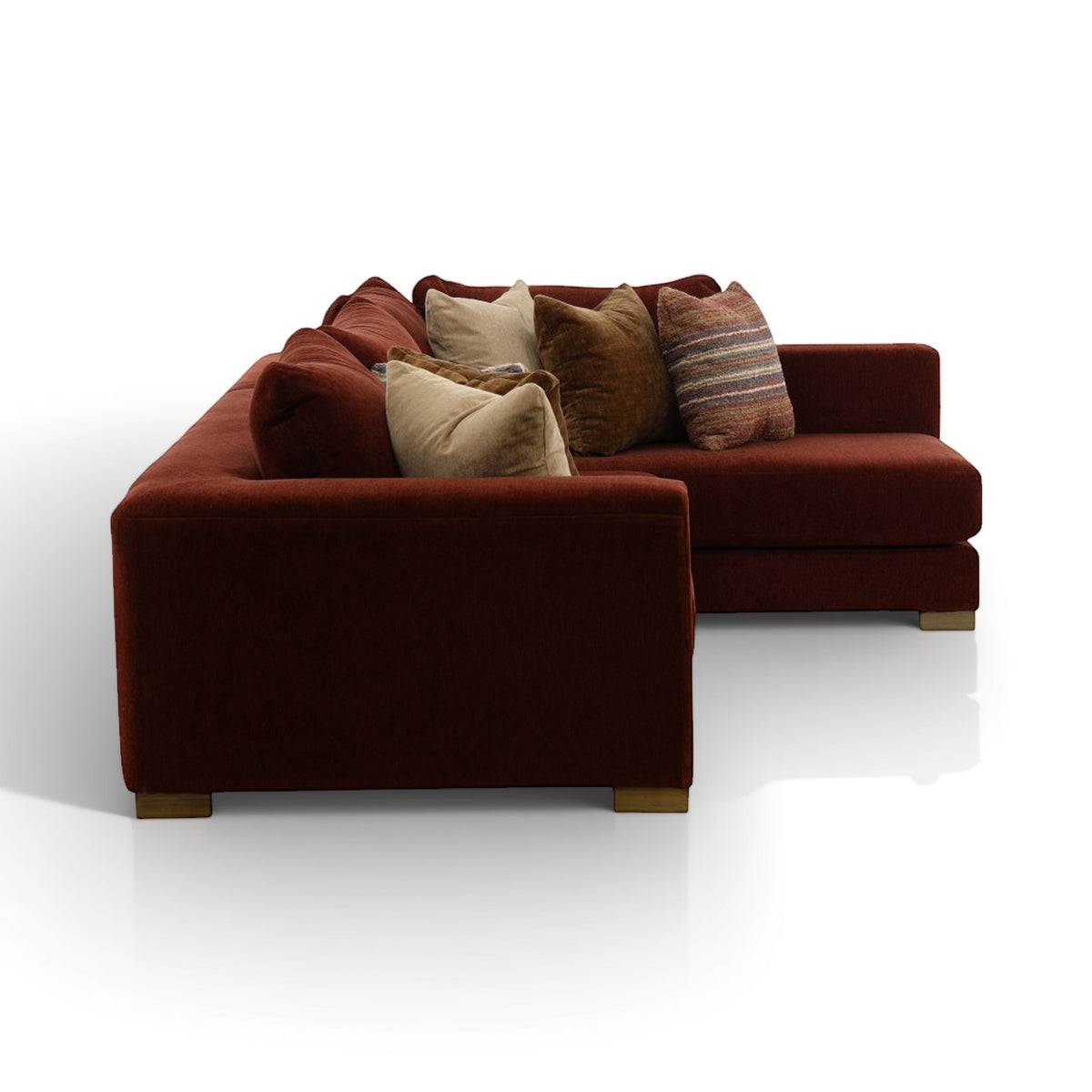 Brown sectional sofa with chaise, wrapped cushions, and decorative pillows