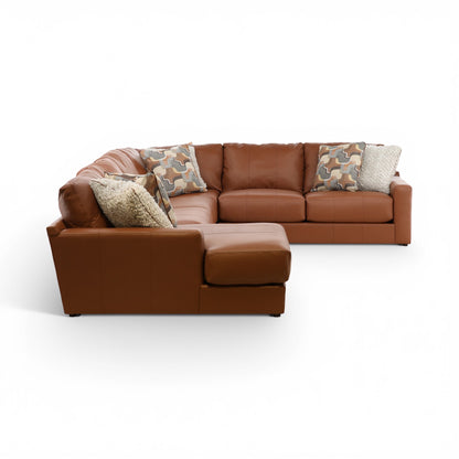 Whiskey brown sectional with left chaise, camo pillows, and textured gray throw cushion