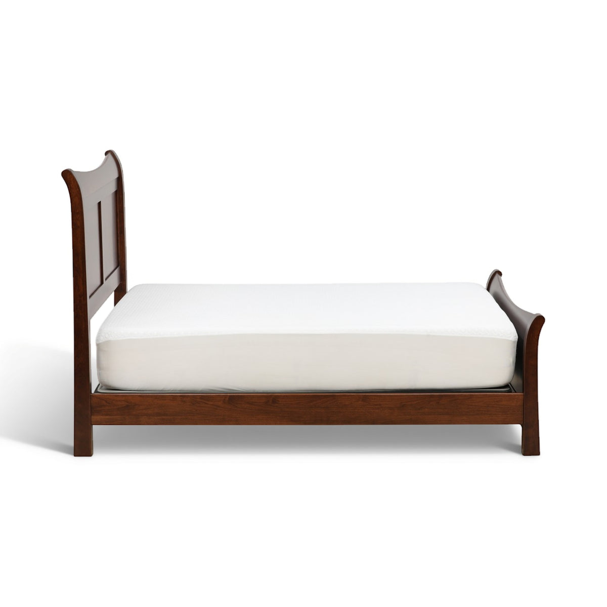 Brown sleigh bed with curved headboard, side rails, and white mattress