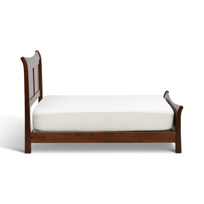 Brown sleigh bed with curved headboard, side rails, and white mattress
