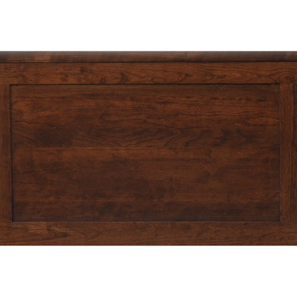 Close-up of brown bed front panel showing engraved wood grain