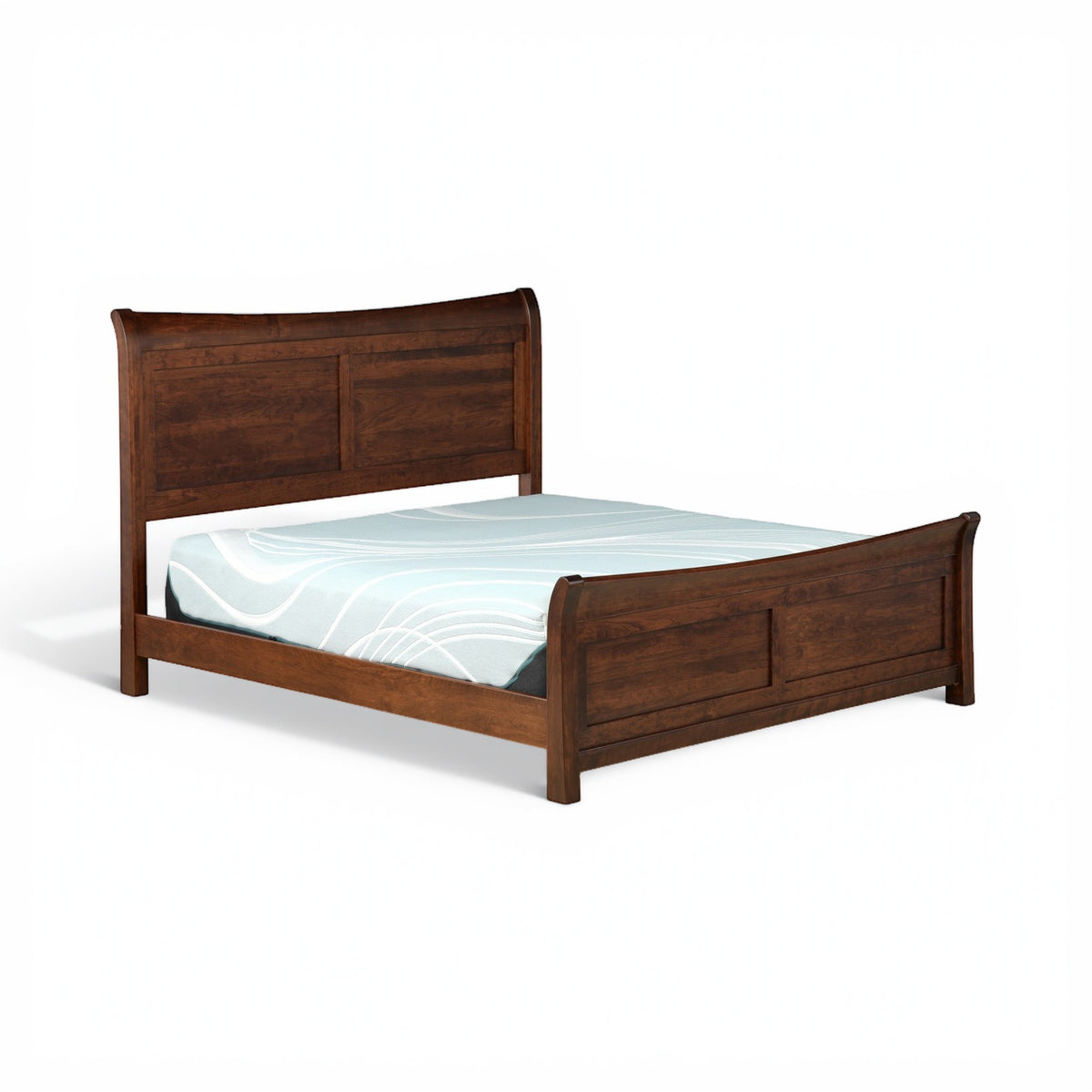 Brown sleigh bed with curved headboard and blue patterned bedding