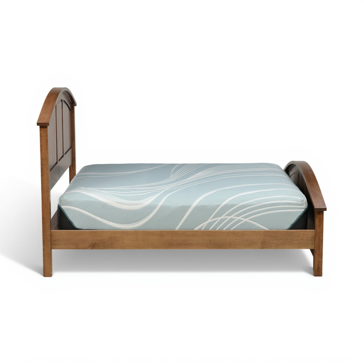 Wood bed with arched end panels and light-blue patterned mattress cover