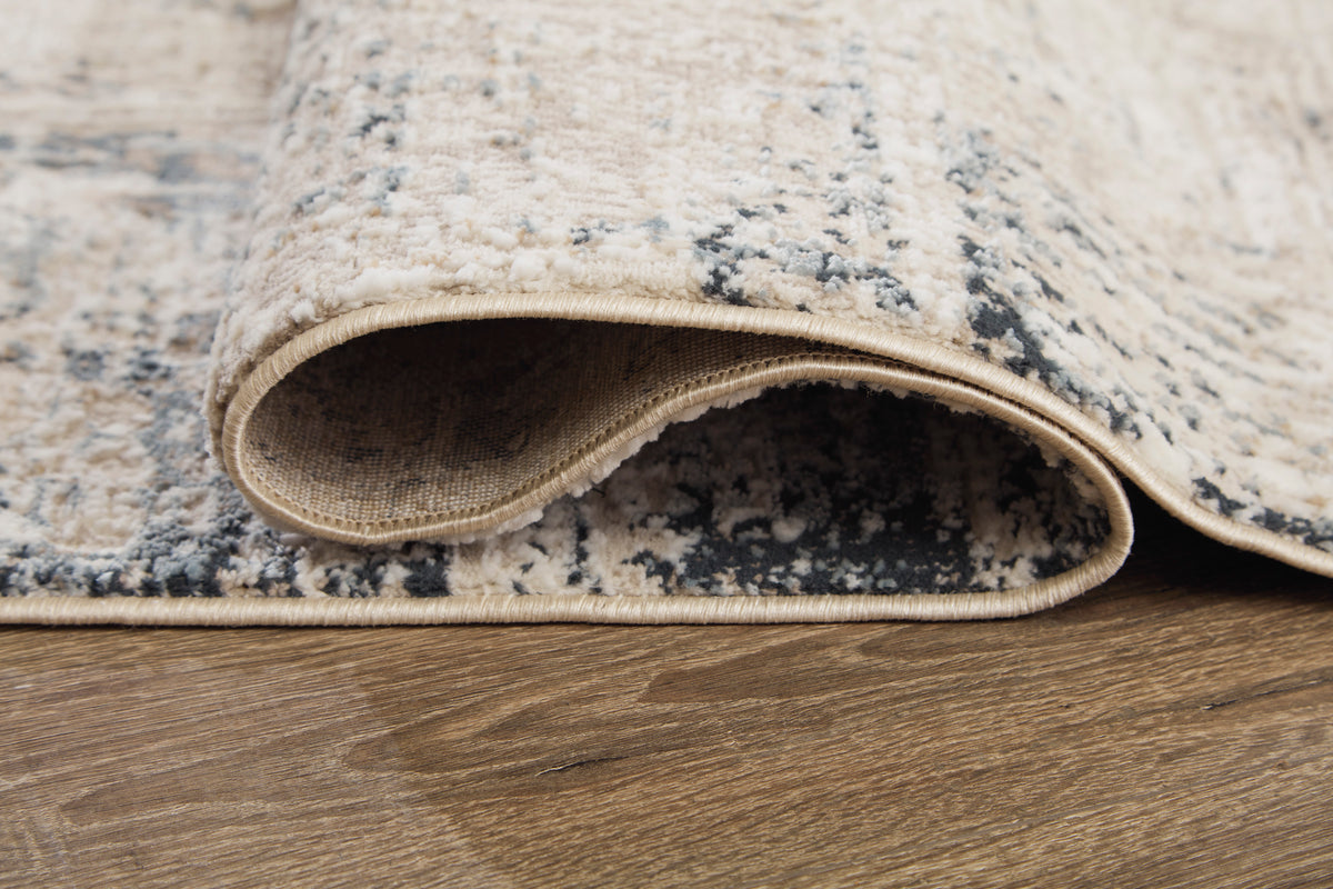 Beige and gray area rug, close-up of textured low-pile edge with border
